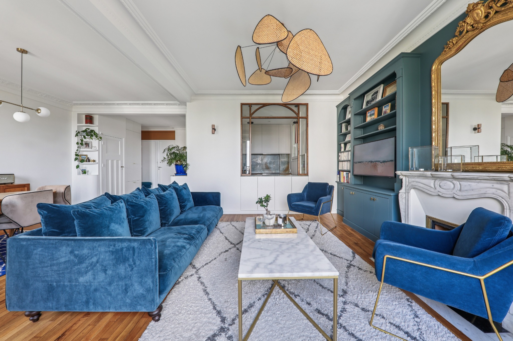 Elegant blue living room with marble fireplace and Parisian details